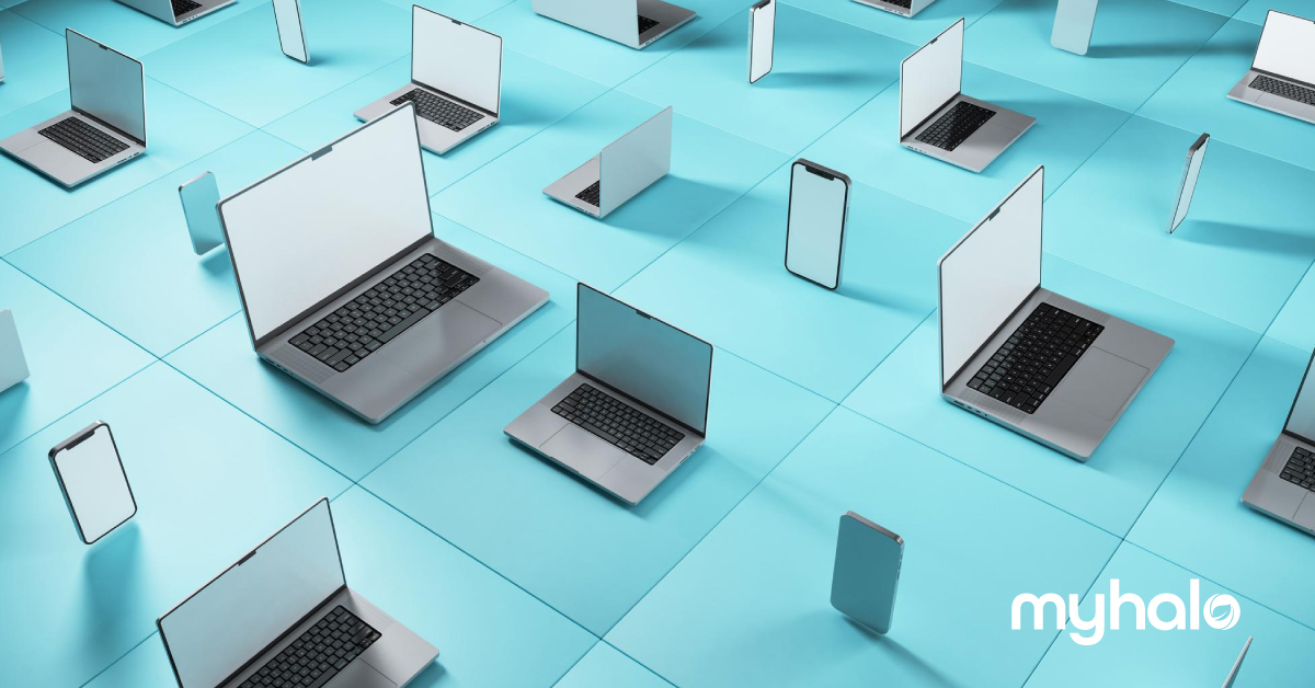multiple phones, laptops and tablets laid out on a table